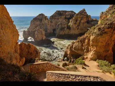 a view of a beach with the ocean and rocks at Beautiful 2 bed townhouse on Boavista golf course in Lagos
