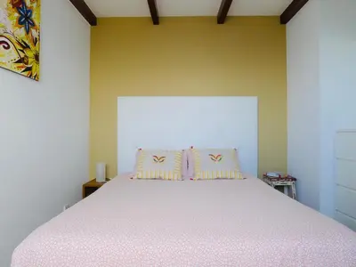 a bedroom with a large bed with two pillows at Atlantis Country House in Calheta