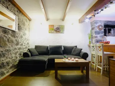a living room with a black couch and a table at Atlantis Country House in Calheta