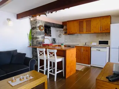 a kitchen with a couch and a table in a room at Atlantis Country House in Calheta