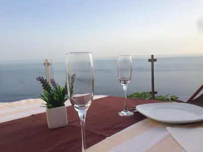 two wine glasses sitting on top of a table at Atlantis Country House in Calheta