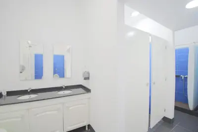 a bathroom with two sinks and a mirror at Santa Maria Hostel in Funchal