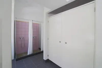 a bathroom with pink walls and a mirror at Santa Maria Hostel in Funchal