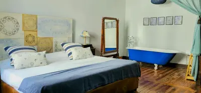 a bedroom with a bed and a bath tub at Santa Maria Hostel in Funchal