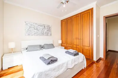 a bedroom with a white bed with two towels on it at Bela Vista Valley in Calheta