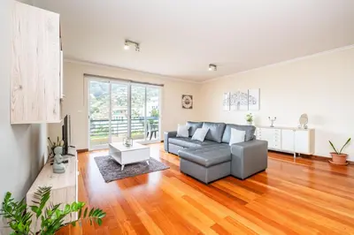 a living room with a couch and a table at Bela Vista Valley in Calheta