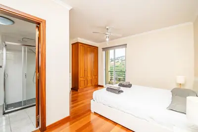 a bedroom with a bed and a large mirror at Bela Vista Valley in Calheta