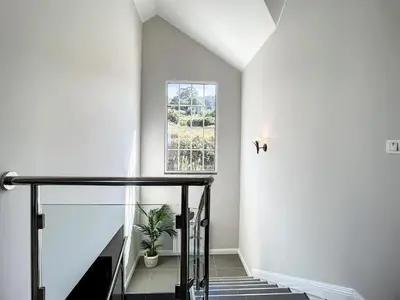 a staircase with a window and a potted plant at Vinhaticos Villa by Atlantic Holiday in Porto Moniz