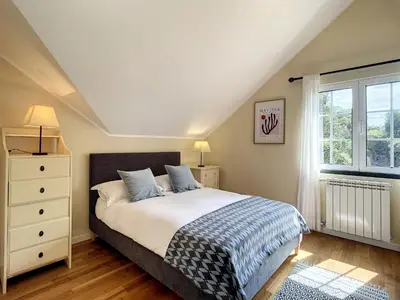a bedroom with a bed and a window at Vinhaticos Villa by Atlantic Holiday in Porto Moniz