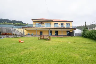 a house with a large yard in front of it at Shell House by GALMI in Arco da Calheta