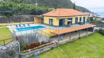 an aerial view of a house with a swimming pool at Shell House by GALMI in Arco da Calheta