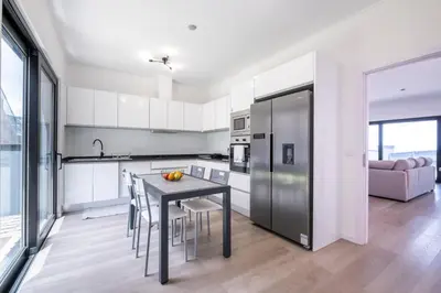a kitchen with a table and chairs in a room at Villa Bela Horizonte by GALMI in Caniço