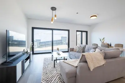 a living room with a couch and a tv at Villa Bela Horizonte by GALMI in Caniço