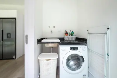 a laundry room with a washing machine and a sink at Villa Bela Horizonte by GALMI in Caniço