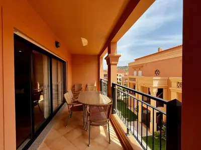 a balcony with a table and chairs at E&M Apartment Luz in Luz