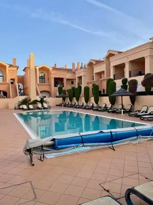 a pool in the courtyard of a resort at E&M Apartment Luz in Luz