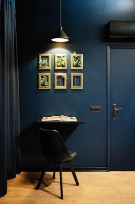 a blue wall with a table and a chair in a room at SUPER Central - Deep Blue in Funchal
