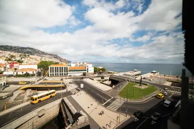 a city street with a bus and a bus at SUPER Central - Deep Blue in Funchal