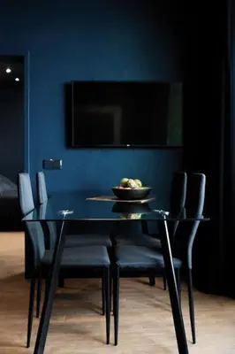 a dining table with chairs and a bowl of fruit on it at SUPER Central - Deep Blue in Funchal