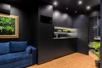 a living room with a blue couch and a sink at SUPER Central - Deep Blue in Funchal