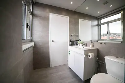 a bathroom with a toilet and a sink and a window at SUPER Central - Silver in Funchal