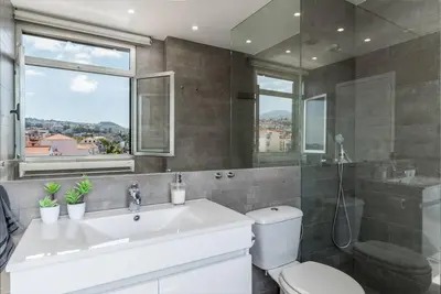 a bathroom with a sink and a toilet and a window at SUPER Central - Silver in Funchal