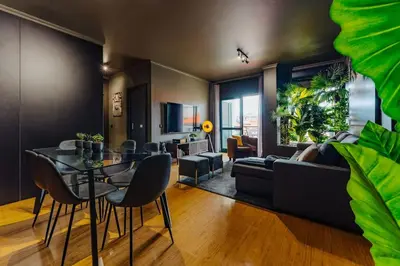a living room with a table and a couch at SUPER Anadia - Golden in Funchal