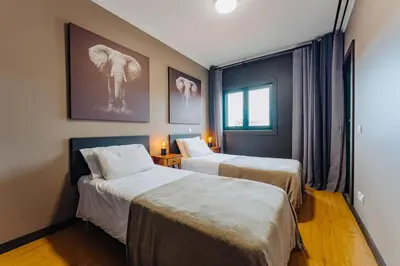 a hotel room with two beds and an elephant on the wall at SUPER Anadia - Golden in Funchal