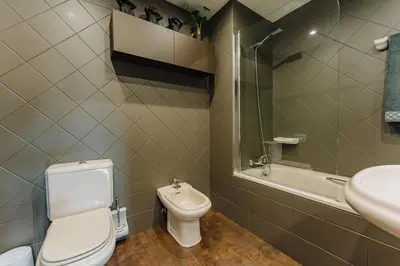 a bathroom with a toilet and a sink and a tub at SUPER Anadia - Golden in Funchal