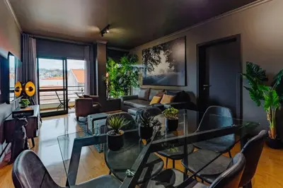 a living room with a glass table and chairs at SUPER Anadia - Golden in Funchal