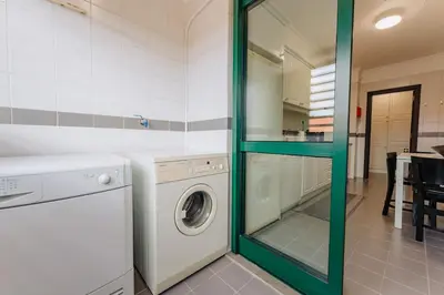a laundry room with a washer and dryer at SUPER Anadia - Golden in Funchal