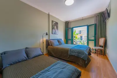 a bedroom with two beds and a window at SUPER Anadia - Olive in Funchal