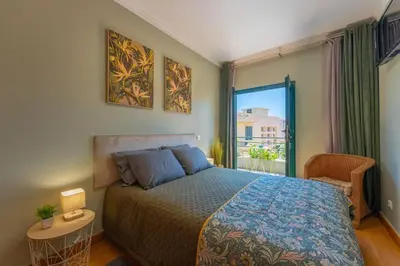 a bedroom with a bed and a large window at SUPER Anadia - Olive in Funchal