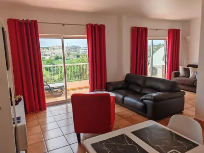a living room with a red chair and a table at Vila Apostol in Lagos