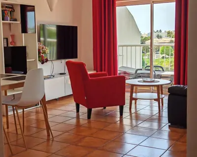 a living room with a brown couch and a table at Vila Apostol in Lagos