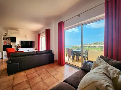 a kitchen and living room with a table and chairs at Vila Apostol in Lagos