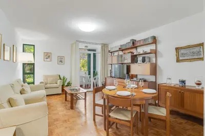 a living room with a table and a dining room at Refugio Madeirense by Atlantic Holiday in Funchal