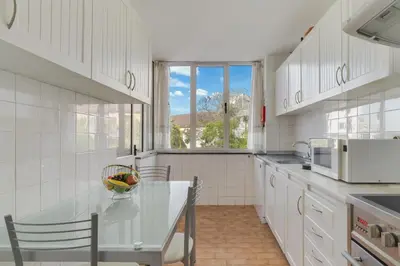 a kitchen with a table and chairs and a window at Refugio Madeirense by Atlantic Holiday in Funchal