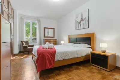 a bedroom with a large bed with a red blanket at Refugio Madeirense by Atlantic Holiday in Funchal