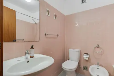 a bathroom with a sink and a toilet and a mirror at Refugio Madeirense by Atlantic Holiday in Funchal