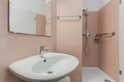 a bathroom with a sink and a shower with a mirror at Refugio Madeirense by Atlantic Holiday in Funchal