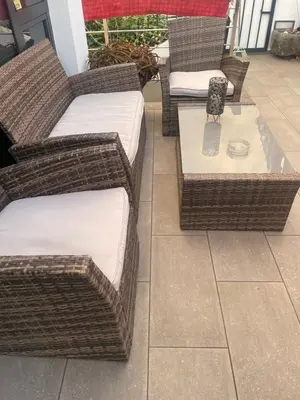 a group of wicker chairs and tables on a patio at Apartamento Deluxe II RB in Ribeira Brava