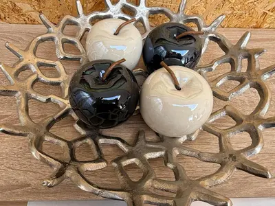 a group of four glass candles on a wooden table at Apartamento Deluxe II RB in Ribeira Brava