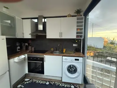 a kitchen with a sink and a washing machine at Apartamento Deluxe II RB in Ribeira Brava