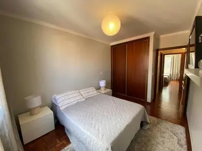 a bedroom with a white bed and a lamp at Residência Azevedo in Câmara de Lobos