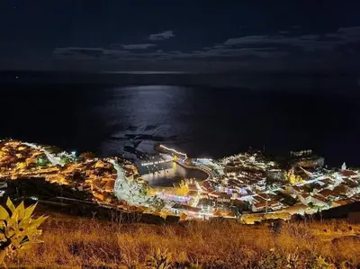 a view of a city at night with lights at Residência Azevedo in Câmara de Lobos