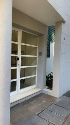 a large glass door on a house at Residência Azevedo in Câmara de Lobos