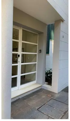 a sliding glass door on the side of a house at Residência Azevedo in Câmara de Lobos