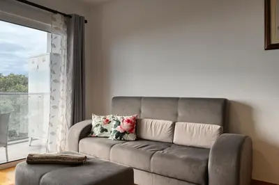 a living room with a couch and a window at Tamariz Sea View, a Home in Madeira in Caniço