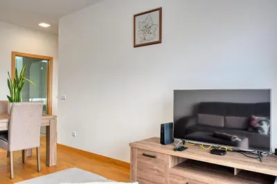 a living room with a television on a wooden table at Tamariz Sea View, a Home in Madeira in Caniço